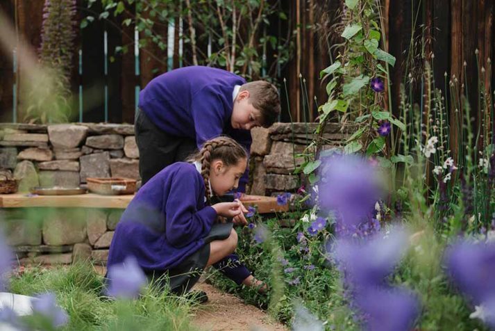 Schoolchildren explore and relax in the 'Mandala' Mindfulness Garden at RHS Chatsworth Flower Show