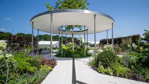 Sunken rills provide a calming babble and lead the eye to a central circular bed dominated by a liquidambar
