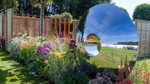 'Torus' a large stainless steel sculpture by David Harber brightens up one corner of the garden.