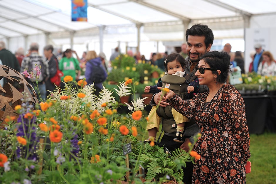 A family look at flowers in the Floral Marquee