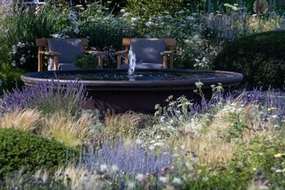 Shaded seating next to a water feature on the Julia Rausing Garden at RHS Badminton Flower Show 2026