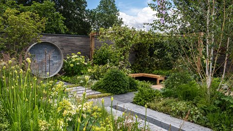 A beautifully simple green and white colour scheme gives this garden a calming quality and encourages the visitor to linger and relax