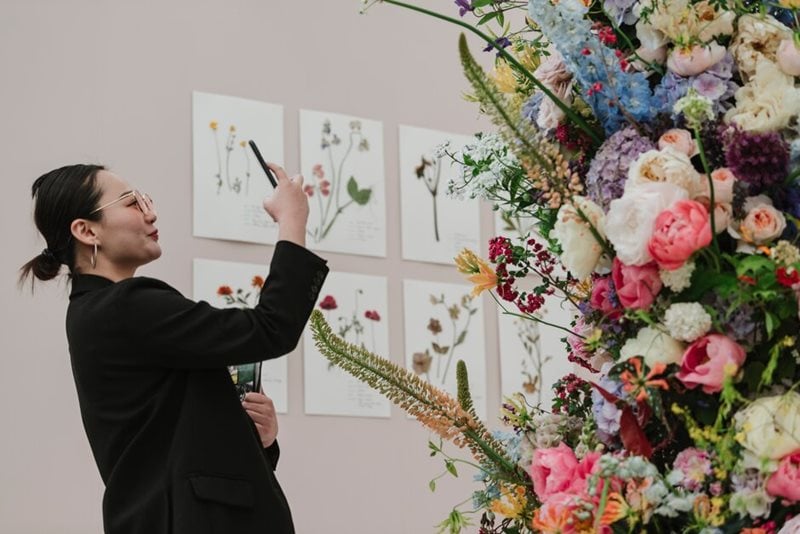 Visitor photographs floristry display