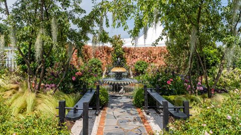 This 'pocket' garden, enclosed by red brick walls, is filled with intricate planting and bespoke landscaping – an accurate representation of the gardens of Charleston.