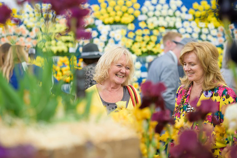 visitors surrounded by flowers at a show
