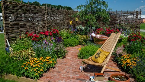 Bee motifs are repeated through this garden along with bug hotels on the surrounding walls