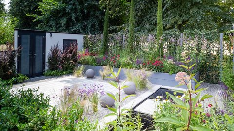 A range of cleverly-integrated features help keep the space secure, including prickly plants around the perimeter, gravel to alert the owners of an intruder, and a privacy fence disguised with ivy.