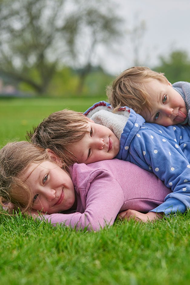 Children lying in a garden