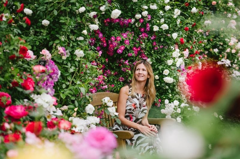 Visitors sits among flowers at RHS Chelsea Flower Show