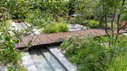 A garden with a contemporary layout but filled with antique items collected from the owners' travels.