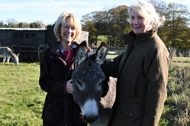 Annie Prebensen and Christina Williams with a donkey