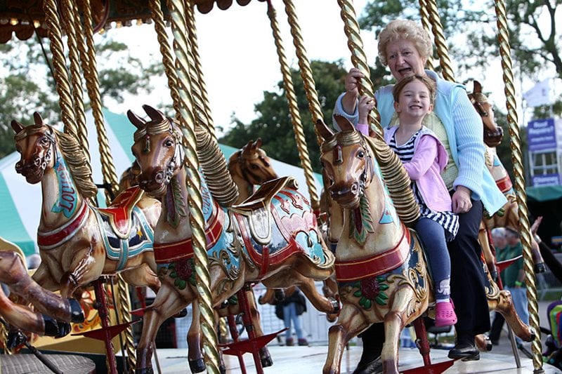 Girl and grandma on carousel