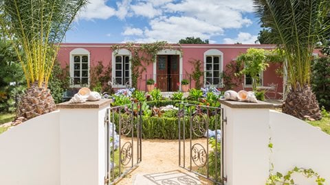 An intriguing blend of plants reminiscent of Spanish, Caribbean and British gardens are cleverly combined to make a lush, exuberant garden that reflects the daring deigns planted by the Indianos