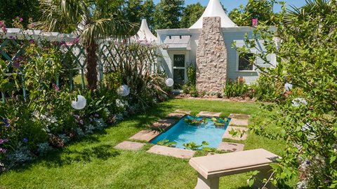 The designer's choice of hardy palms and waterlilies mean that many elements of this garden could be successfully re-used in British gardens.