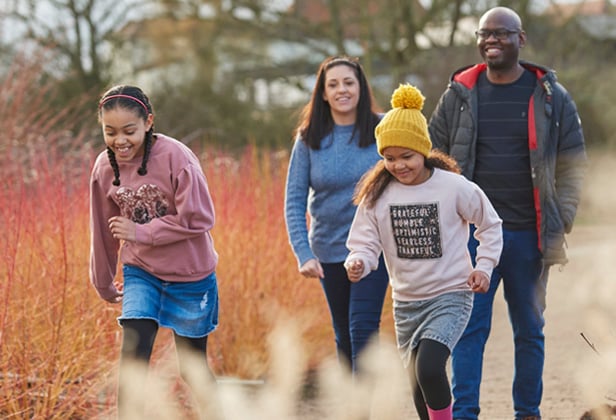 Photo of a family on a summer day walking through RHS Hude Hall