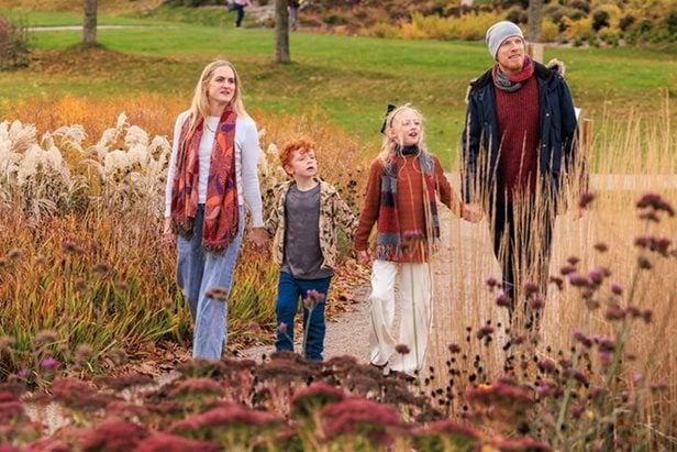Photo of a family on a summer day walking through RHS Hude Hall