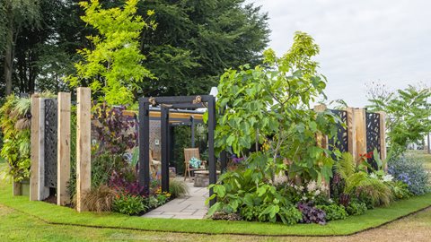 Tropical-inspired planting abounds, with big foliage, bold colours and plenty of hard landscaping materials filling this secluded private space.