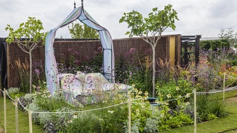 The ultimate garden for relaxation and waking up refreshed. Peaceful planting surrounds a bed covered with a bespoke quilt the colours of which mirror the cool pallet of the flowers and foliage.