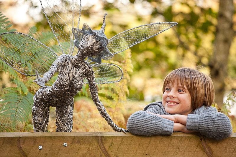 Boy with fairy sculpture