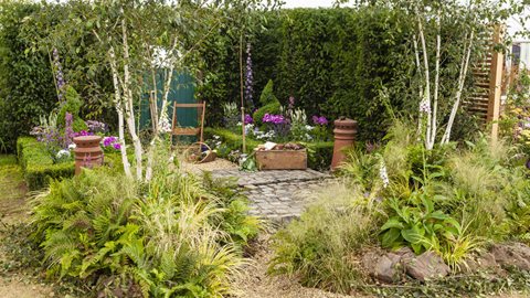 A tiny and symmetrical woodland space, complete with leafy understore, at this garden's entrance gives way to more formal planting and restful planting at the rear.