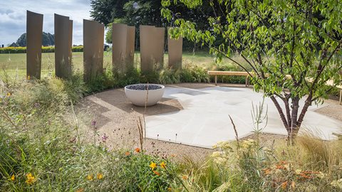Mixing perennials and grasses, the 'frothy' planting around the circular layout has been designed to link to the garden's theme of the brewing industry.
