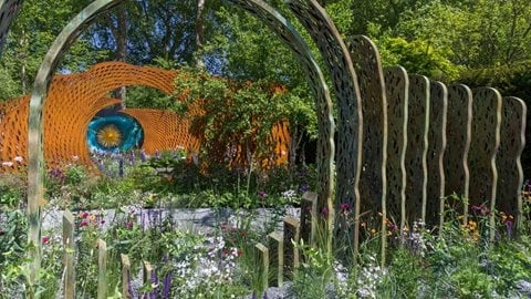 Rich, colourful planting, impressive structures and a broad meandering path of gravel, then brick and finally stone that takes visitors on a subtle transitional journey.