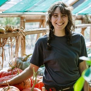 Student working in a greehouse