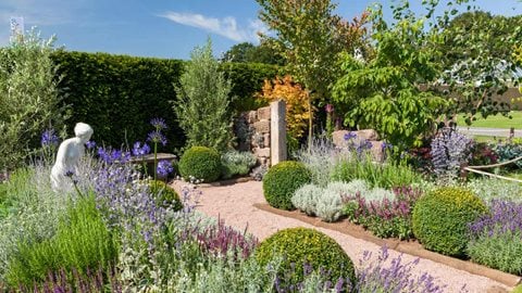 The formal garden features the statue of a woman taken from Cholmondeley Castle Gardens