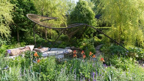 The 9m tall willow trees form a shady, cool backdrop to this softly planted and inviting space designed for stopping a while.