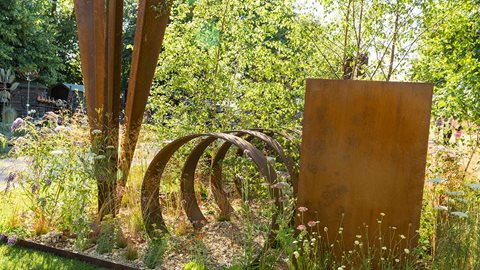 Specially designed steel sculptures give this garden great structure - they are softened by naturalised planting.