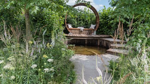 A woodland garden surrounded by trees creates a calming central place to reflect and take a moment
