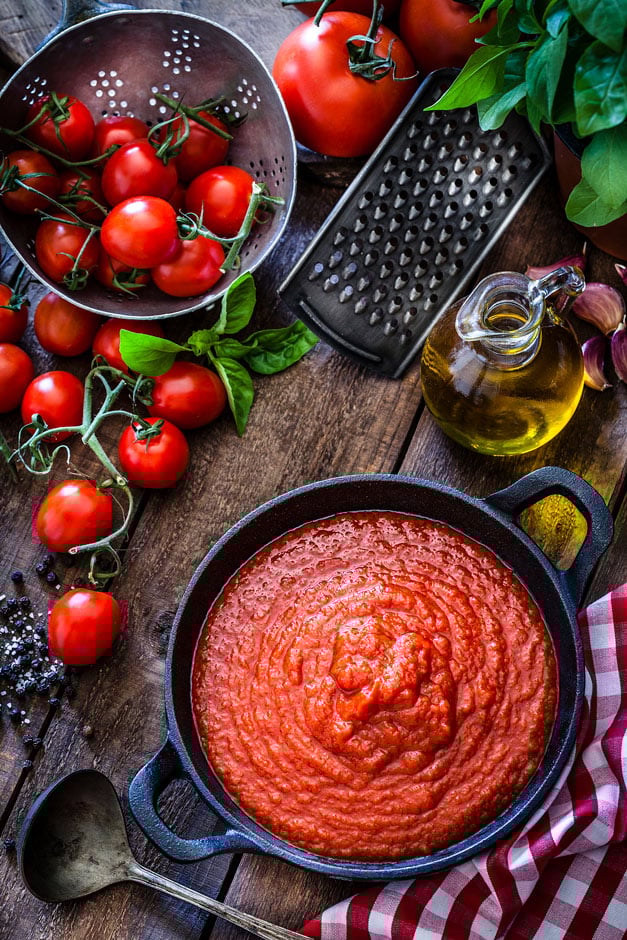 A bowl of passata, pictured with fresh tomatoes and basil A bowl of passata, pictured with fresh tomatoes and basil