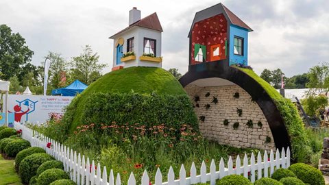 Remarkable 'Mr Men' themed garden marking 30 years of the charity Children with Cancer, filled with symbolism and and impressive detail with a feature hill, split in two.