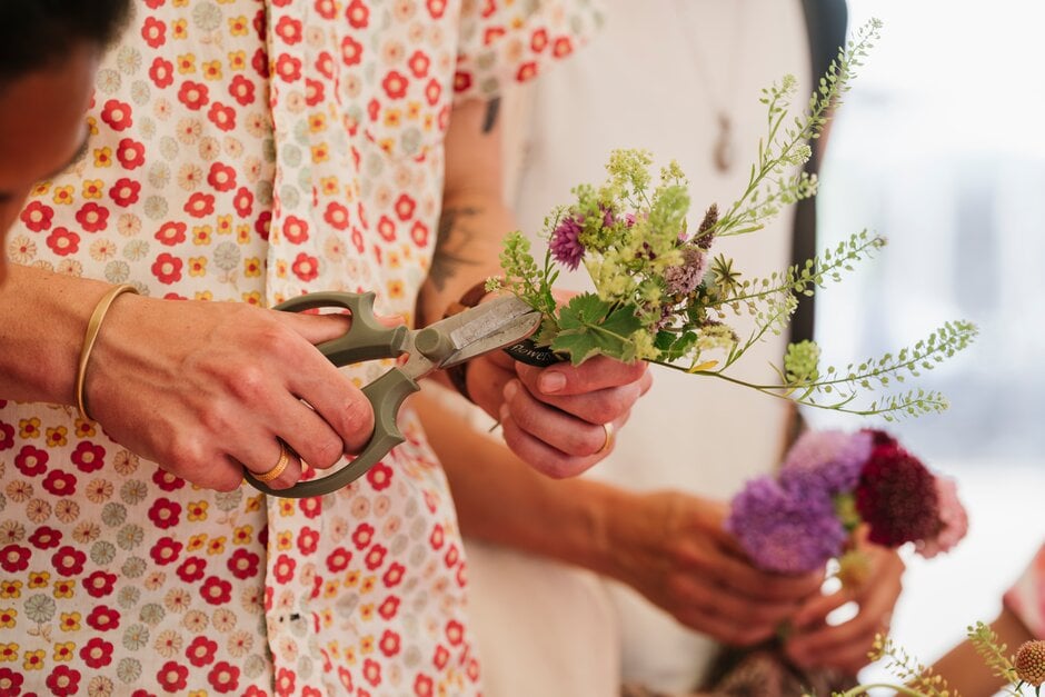 Visitors learn to make posies at the RHS Flower School with Flowers from the Farm. RHS Hampton Court Palace Garden Festival 2022.