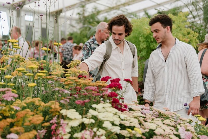 Visitors browse the Floral Marquee