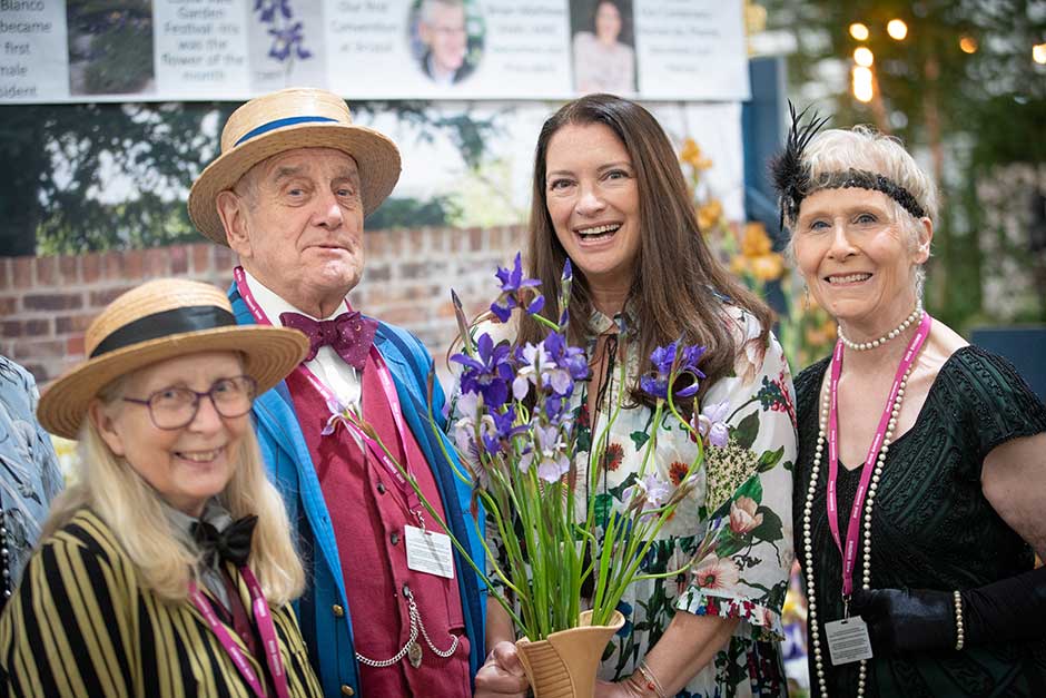 TV Presenter and Patron of the British Iris Society Rachel de Thame poses with members of the society at the RHS Chelsea Flower Show