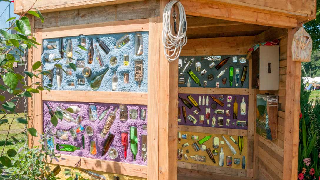 This hexagonal cabin called the 'Room of Inklings' dominates a corner of the garden. It contains glass bottles full of items like sea shells, garden tools and marbles to spark memories of dimentia pat