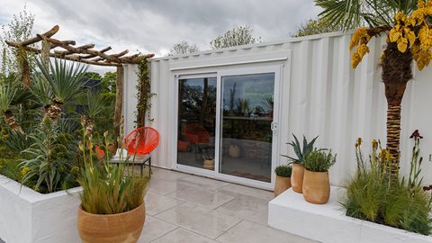The planting scheme and white backdrop give a sense of a typical Mediterranean scene