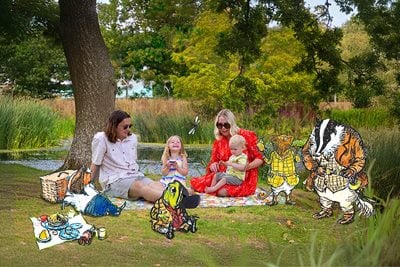 Family enjoying picnic with Wind in the Willows characters